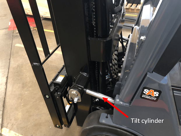 Attached tilt cylinder on a Toyota forklift. The red arrow indicates its location.